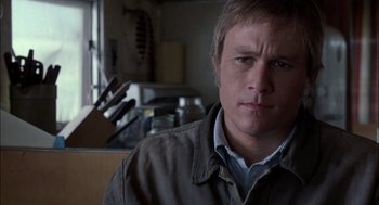 Movie still from “Brokeback Mountain” (2005), directed by Ang Lee – A person wearing a jacket in a room; Close Up shot, Over the shoulder angle