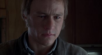 Movie still from “Brokeback Mountain” (2005), directed by Ang Lee – A person with a sad look on his face; Close Up shot, Low angle