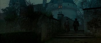 Movie still from “Brotherhood of the Wolf” (2001), directed by Christophe Gans – Two people are walking up the steps in front of a castle; Extreme Wide shot, High angle