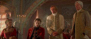 Movie still from “Brotherhood of the Wolf” (2001), directed by Christophe Gans – A man and a woman standing next to each other in a room; Medium shot, Low angle