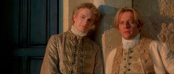 Movie still from “Brotherhood of the Wolf” (2001), directed by Christophe Gans – A man in a suit standing next to another man in a suit; Close Up shot, Low angle