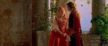 Movie still from “Brotherhood of the Wolf” (2001), directed by Christophe Gans – Two people dressed in medieval clothing standing next to each other; Medium shot, Over the shoulder angle