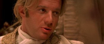 Movie still from “Brotherhood of the Wolf” (2001), directed by Christophe Gans – A person wearing a shirt and tie; Close Up shot, Over the shoulder angle