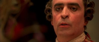 Movie still from “Brotherhood of the Wolf” (2001), directed by Christophe Gans – A person with curly hair; Close Up shot, High angle