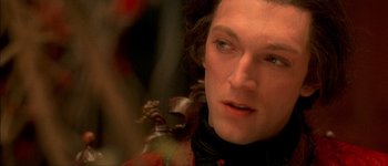 Movie still from “Brotherhood of the Wolf” (2001), directed by Christophe Gans – A person with a violin; Close Up shot, Over the shoulder angle