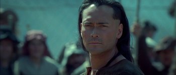 Movie still from “Brotherhood of the Wolf” (2001), directed by Christophe Gans – A person with long black hair; Close Up shot, Over the shoulder angle
