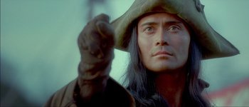Movie still from “Brotherhood of the Wolf” (2001), directed by Christophe Gans – A person wearing a hat; Close Up shot, Over the shoulder angle