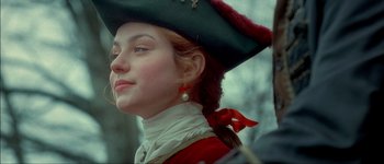 Movie still from “Brotherhood of the Wolf” (2001), directed by Christophe Gans – A young woman wearing a pirate's hat and a red bow; Close Up shot, Over the shoulder angle