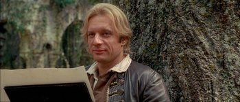 Movie still from “Brotherhood of the Wolf” (2001), directed by Christophe Gans – A man with blonde hair wearing a leather jacket holding papers; Close Up shot, Over the shoulder angle