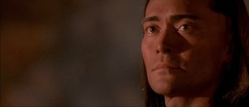 Movie still from “Brotherhood of the Wolf” (2001), directed by Christophe Gans – A man's face in a dark room; Close Up shot, Over the shoulder angle