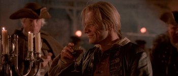 Movie still from “Brotherhood of the Wolf” (2001), directed by Christophe Gans – A person holding a glass of wine; Close Up shot, Over the shoulder angle