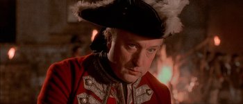 Movie still from “Brotherhood of the Wolf” (2001), directed by Christophe Gans – A person wearing a hat; Close Up shot, Over the shoulder angle