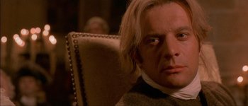 Movie still from “Brotherhood of the Wolf” (2001), directed by Christophe Gans – A person sitting in a chair; Close Up shot, Over the shoulder angle