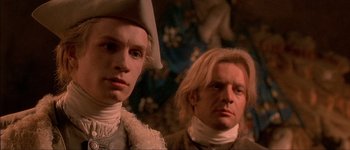 Movie still from “Brotherhood of the Wolf” (2001), directed by Christophe Gans – Two men dressed in renaissance clothing looking at the camera; Close Up shot, Low angle