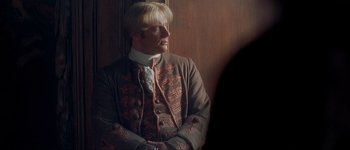 Movie still from “Brotherhood of the Wolf” (2001), directed by Christophe Gans – A man wearing a suit and a wig; Medium shot, Over the shoulder angle