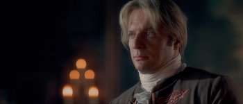 Movie still from “Brotherhood of the Wolf” (2001), directed by Christophe Gans – A person wearing a suit and tie; Close Up shot, Over the shoulder angle