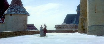 Movie still from “Brotherhood of the Wolf” (2001), directed by Christophe Gans – Two people standing in the middle of a snowy field; Extreme Wide shot, Low angle