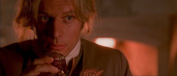 Movie still from “Brotherhood of the Wolf” (2001), directed by Christophe Gans – A person holding a glass of wine; Close Up shot, Over the shoulder angle