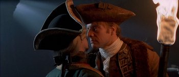 Movie still from “Brotherhood of the Wolf” (2001), directed by Christophe Gans – A man and a woman dressed in period costumes; Close Up shot, Over the shoulder angle