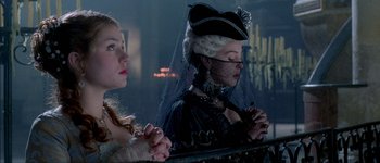 Movie still from “Brotherhood of the Wolf” (2001), directed by Christophe Gans – Two women dressed in medieval garb , one of which is praying; Close Up shot, Low angle