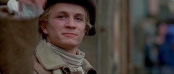 Movie still from “Brotherhood of the Wolf” (2001), directed by Christophe Gans – A young man wearing a hat and a scarf; Close Up shot, Low angle