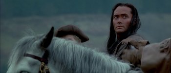 Movie still from “Brotherhood of the Wolf” (2001), directed by Christophe Gans – A woman standing next to an animal on a field; Close Up shot, Over the shoulder angle