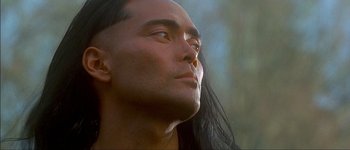 Movie still from “Brotherhood of the Wolf” (2001), directed by Christophe Gans – A person with long black hair; Close Up shot, Low angle