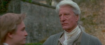 Movie still from “Brotherhood of the Wolf” (2001), directed by Christophe Gans – An older man with white hair and a white beard; Close Up shot, Over the shoulder angle