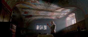Movie still from “Brotherhood of the Wolf” (2001), directed by Christophe Gans – A person standing in a room with a painting on the ceiling; Wide shot, Low angle