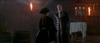 Movie still from “Brotherhood of the Wolf” (2001), directed by Christophe Gans – A man and a woman standing next to each other; Medium shot, Over the shoulder angle