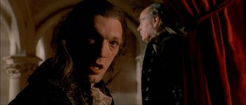 Movie still from “Brotherhood of the Wolf” (2001), directed by Christophe Gans – A man and a woman are standing next to each other; Close Up shot, Over the shoulder angle