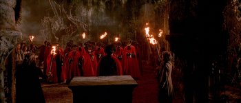 Movie still from “Brotherhood of the Wolf” (2001), directed by Christophe Gans – A group of people dressed in red holding torches; Extreme Wide shot, High angle