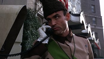 Movie still from “Bullitt” (1968), directed by Peter Yates – A man in a uniform talking on a phone; Close Up shot, Low angle