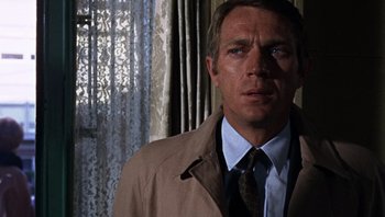 Movie still from “Bullitt” (1968), directed by Peter Yates – A person wearing a suit and tie; Close Up shot, Over the shoulder angle