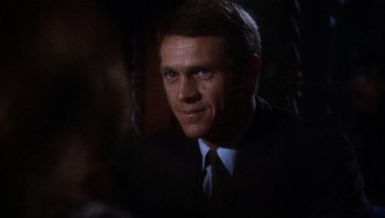 Movie still from “Bullitt” (1968), directed by Peter Yates – A person wearing a suit and tie; Close Up shot, Over the shoulder angle