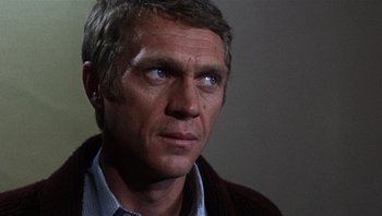 Movie still from “Bullitt” (1968), directed by Peter Yates – A person wearing a shirt; Close Up shot, Over the shoulder angle