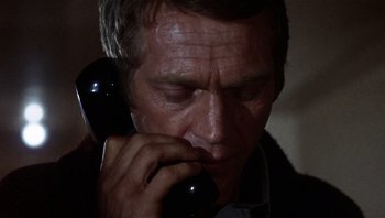 Movie still from “Bullitt” (1968), directed by Peter Yates – A person talking on a phone; Close Up shot, Low angle