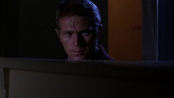 Movie still from “Bullitt” (1968), directed by Peter Yates – A man looking at a computer screen in the dark; Close Up shot, Over the shoulder angle