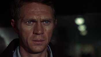 Movie still from “Bullitt” (1968), directed by Peter Yates – A man's face in the dark; Close Up shot, Over the shoulder angle