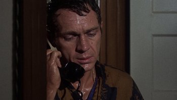 Movie still from “Bullitt” (1968), directed by Peter Yates – A person talking on a phone; Close Up shot, High angle