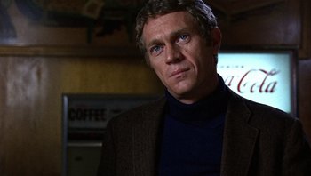 Movie still from “Bullitt” (1968), directed by Peter Yates – A person wearing a jacket; Close Up shot, Over the shoulder angle