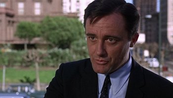Movie still from “Bullitt” (1968), directed by Peter Yates – A person wearing a suit and tie; Close Up shot, Low angle
