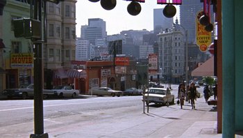 Movie still from “Bullitt” (1968), directed by Peter Yates – A street scene with cars parked on the side of the road; Extreme Wide shot, High angle