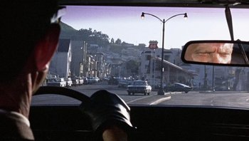 Movie still from “Bullitt” (1968), directed by Peter Yates – A view from a car window of a city street; Wide shot, Over the shoulder angle