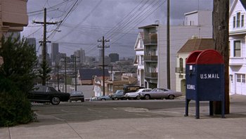 Movie still from “Bullitt” (1968), directed by Peter Yates – Cars parked on the side of the road near a telephone pole; Extreme Wide shot, High angle