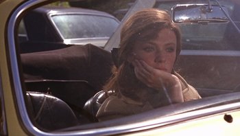 Movie still from “Bullitt” (1968), directed by Peter Yates – A woman sitting in the passenger seat of a car; Close Up shot, Over the shoulder angle