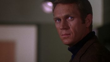 Movie still from “Bullitt” (1968), directed by Peter Yates – A man that is looking at the camera; Close Up shot, Over the shoulder angle