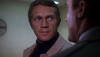 Movie still from “Bullitt” (1968), directed by Peter Yates – A person wearing a suit and tie; Close Up shot, Over the shoulder angle
