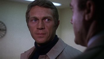 Movie still from “Bullitt” (1968), directed by Peter Yates – A person wearing a jacket; Close Up shot, Over the shoulder angle