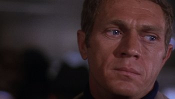 Movie still from “Bullitt” (1968), directed by Peter Yates – A man's face with blue eyes; Close Up shot, Over the shoulder angle